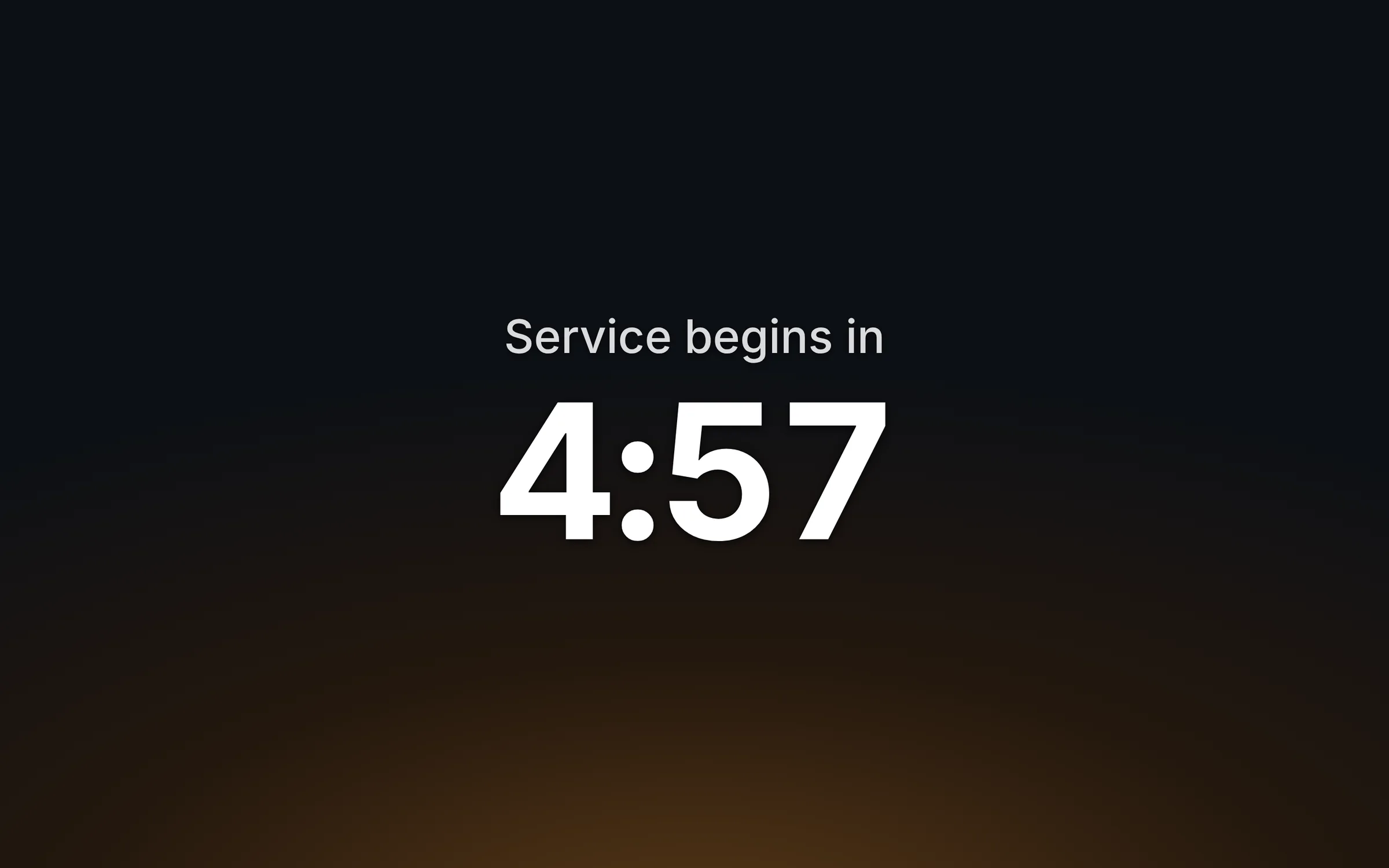 A pre-service countdown on the projector: Service begins in 4:57, in large white numerals over a warm glow.